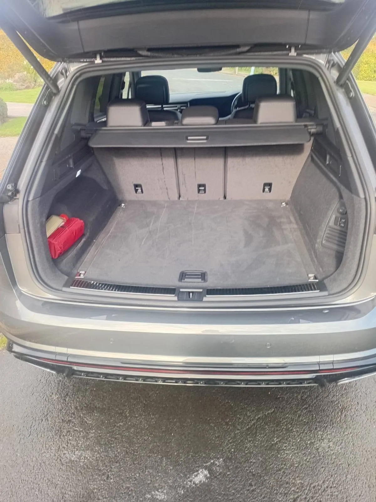 Open boot of a grey Volkswagen Touareg, carpet vacuumed and tidy